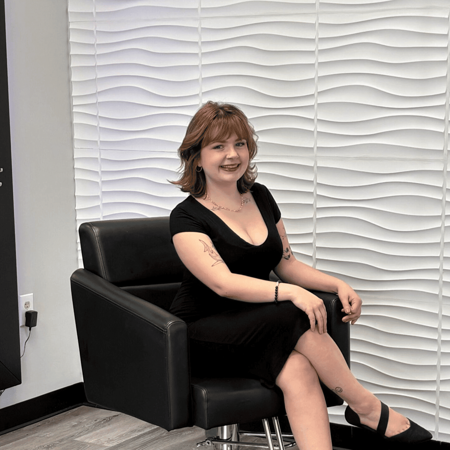 Portrait of Lilly, a professional stylist at Elevate Beauty Lounge, showcasing their expertise and style.